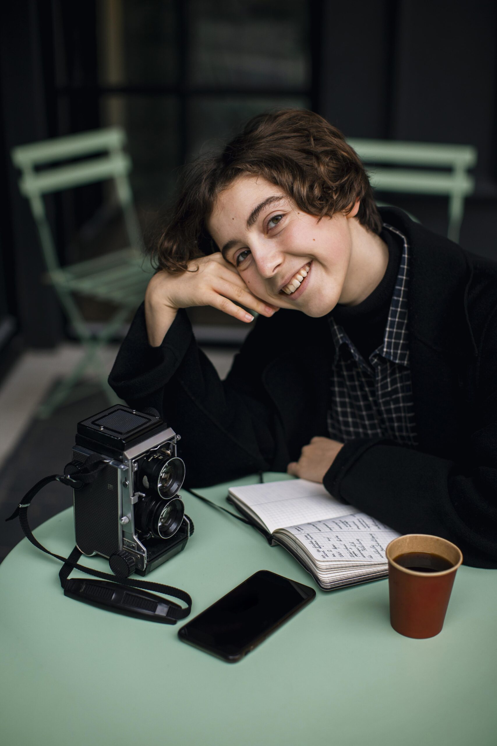 Smiling girl with camera and coffee. - Run It By Britt